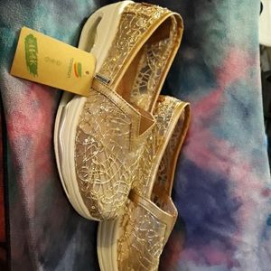 Pair of gold slip on shoes